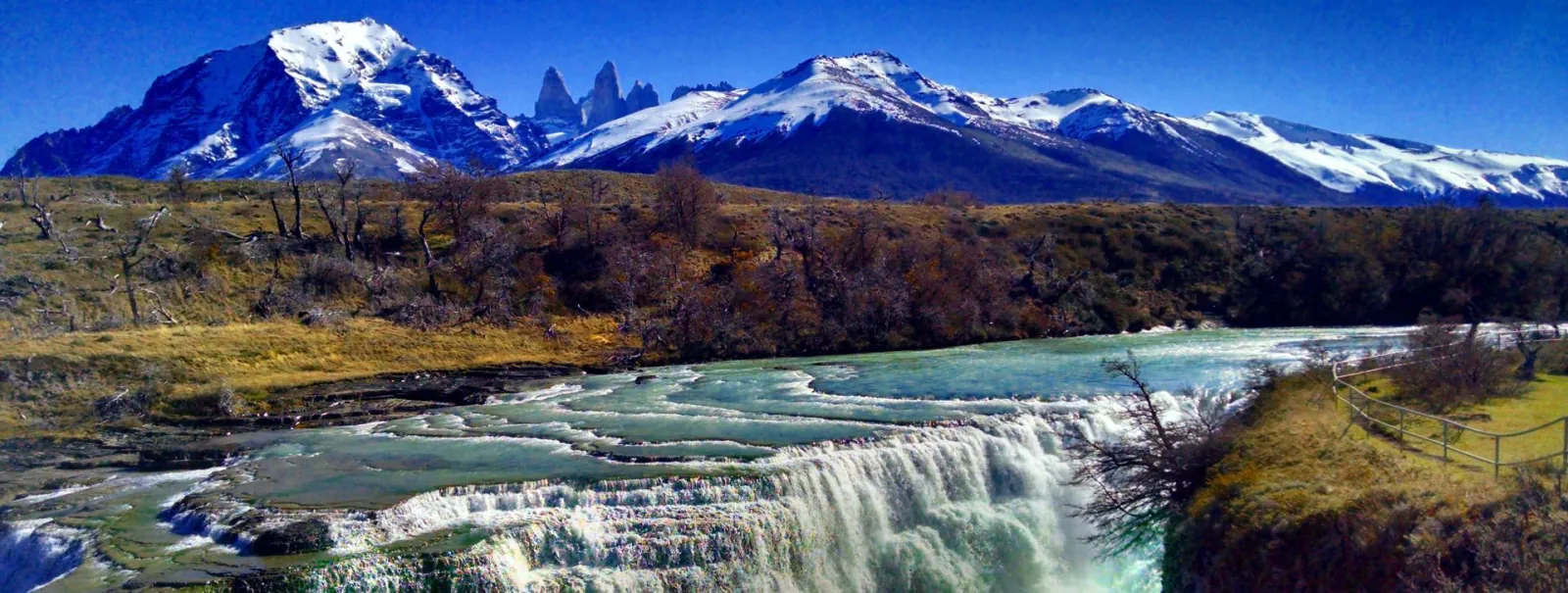 Paine River cascades below the snow-capped massif