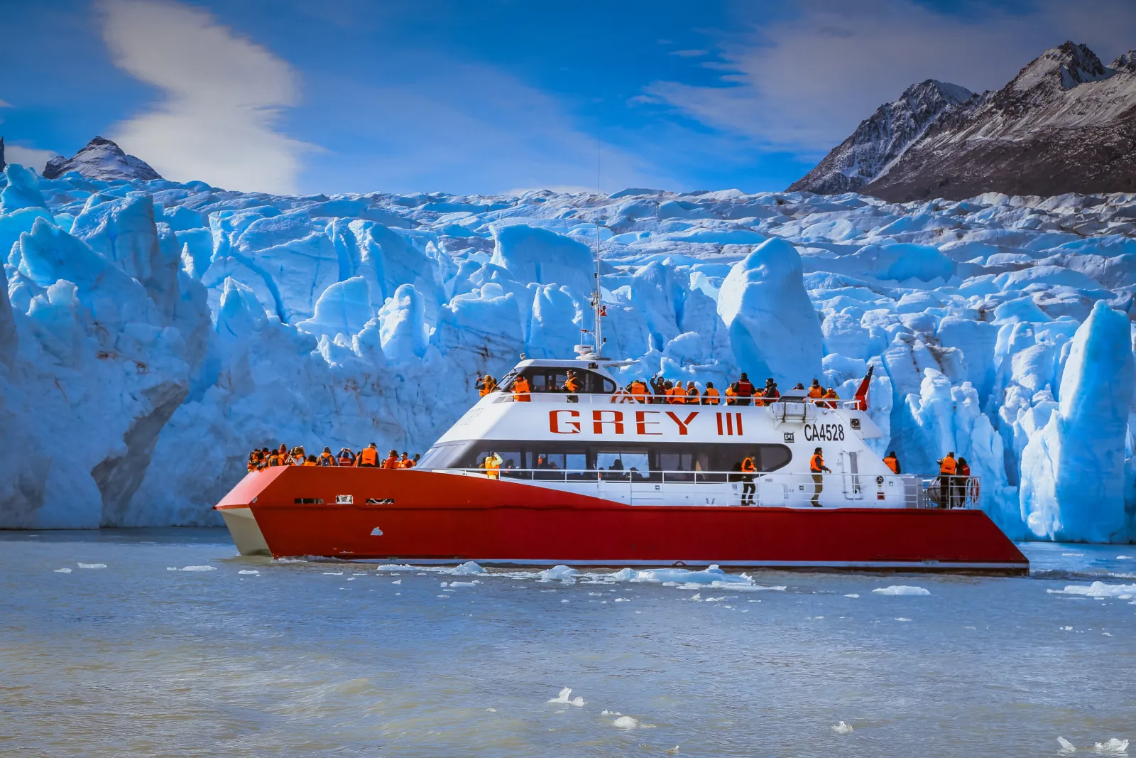Grey III catamaran in front of the Grey Glacier ice wall