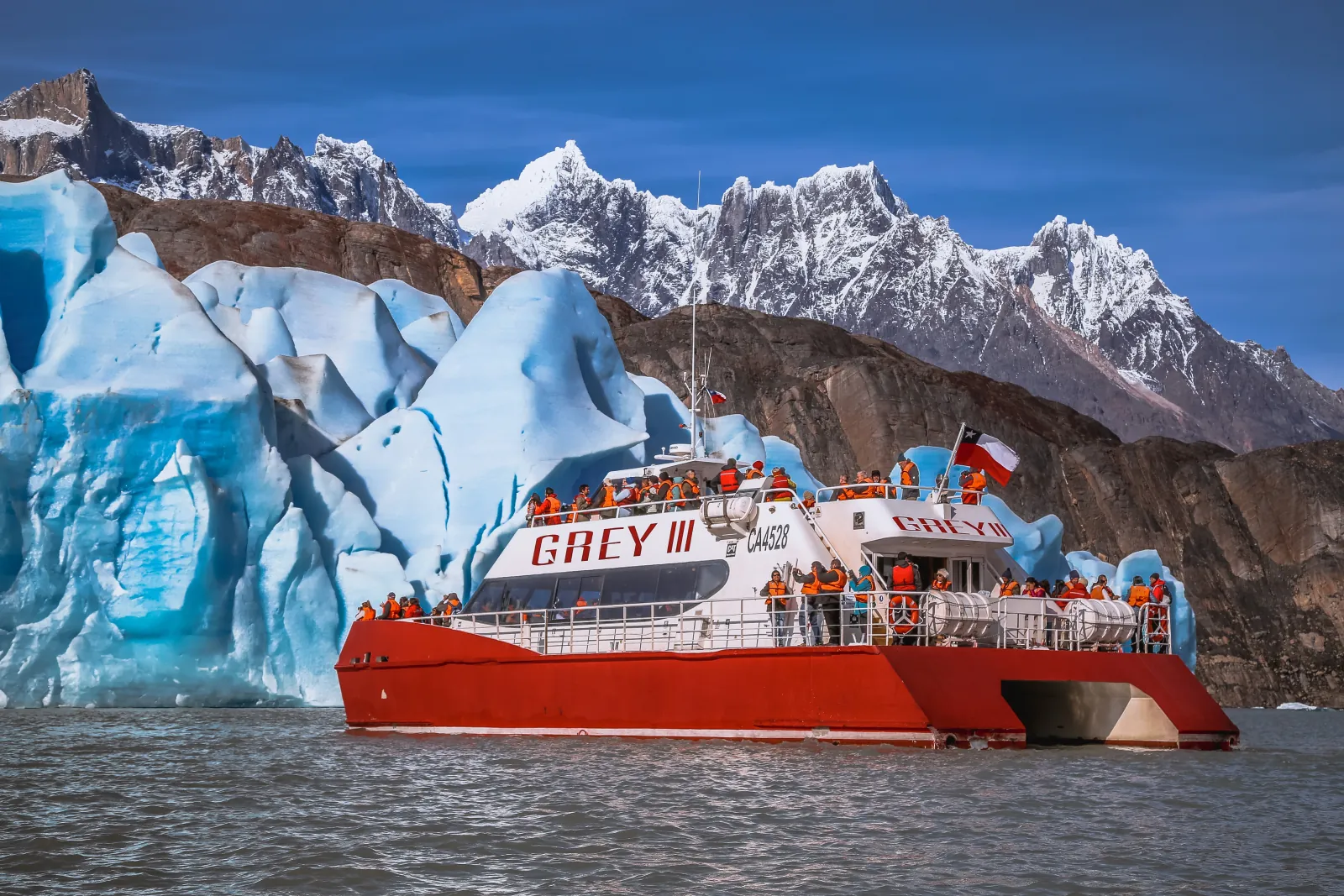 Passengers on deck as the catamaran nears the glacier face