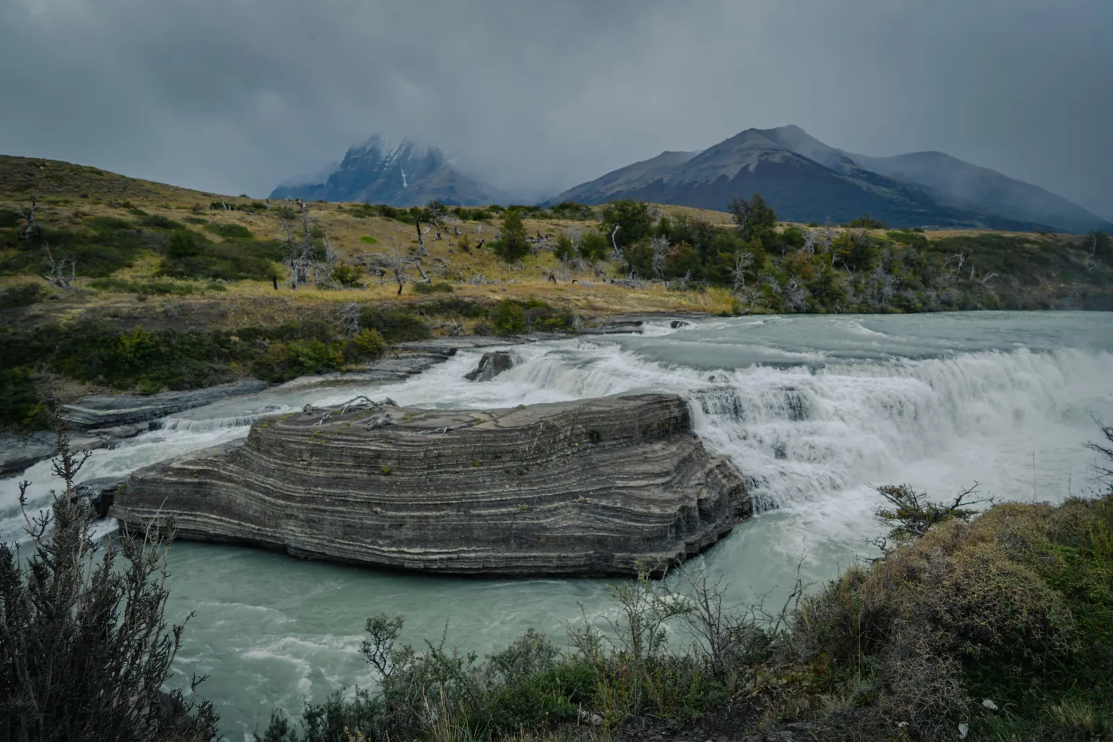 Salto Grande waterfall on the Paine River under storm clouds