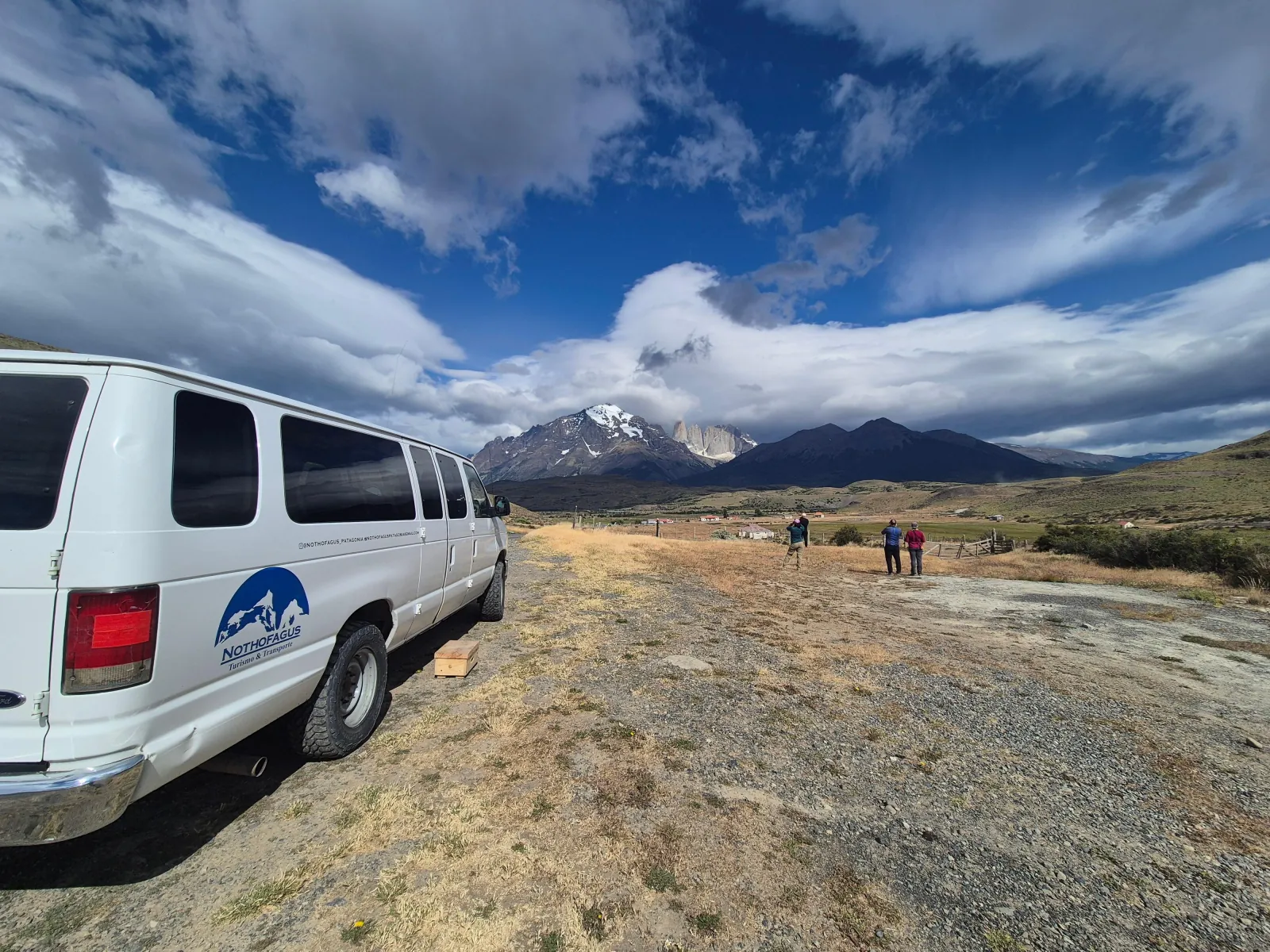 Small-group van parked at a steppe viewpoint