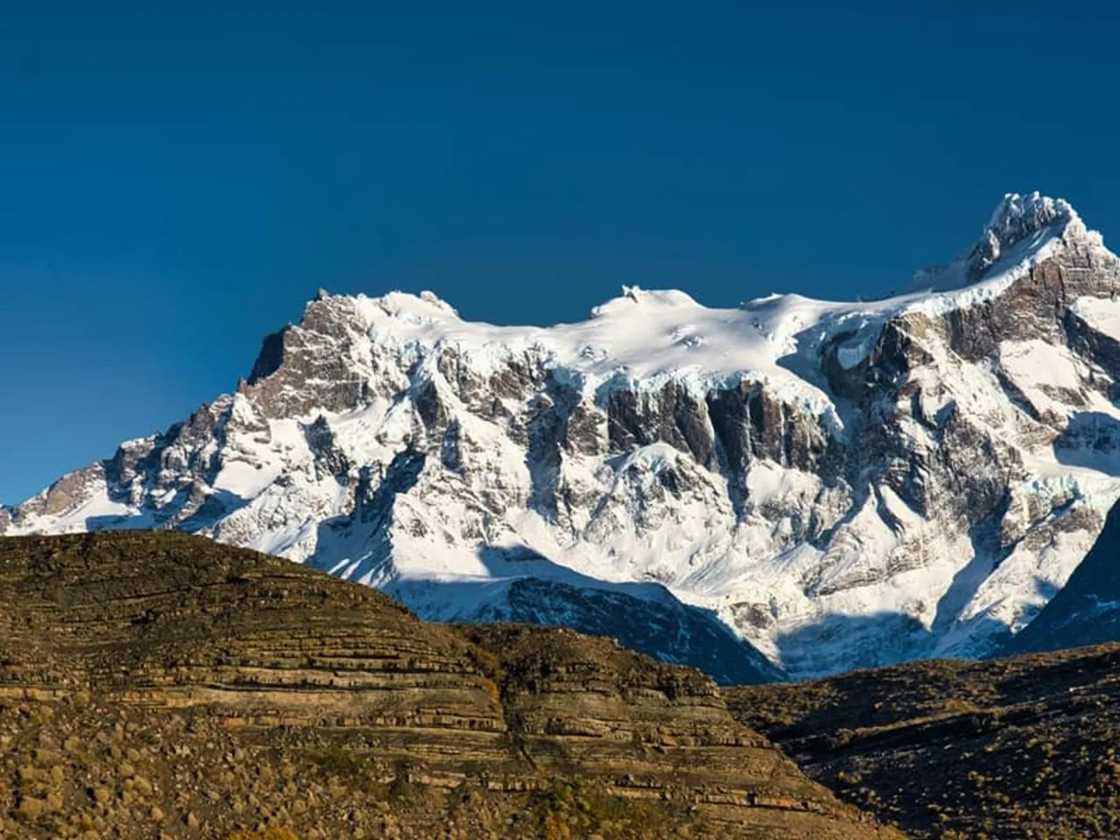 Glaciated Paine Grande above layered hillsides
